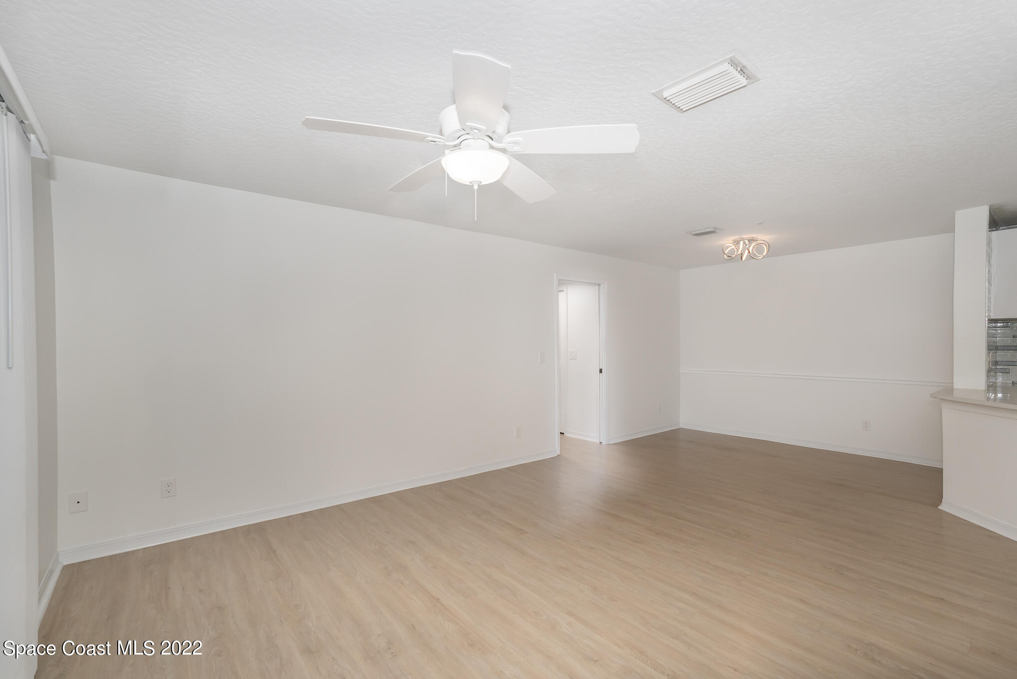 7667 North Wickham Road, Unit 113 Melbourne, FL 32940 - Photo 10 of 29 wooden floor in an empty room