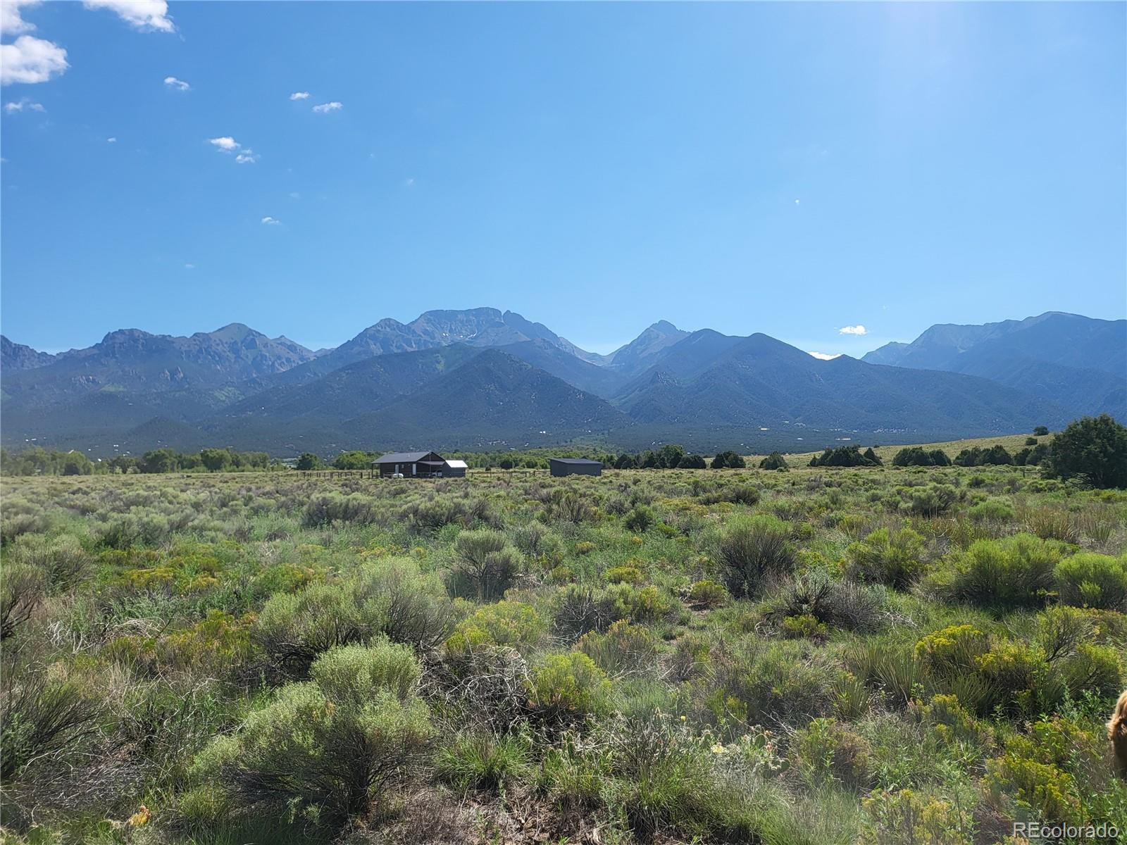 993 Pinon Road Crestone, CO 81131 - Photo 12 of 42 a view of a lush green field with mountains in the background
