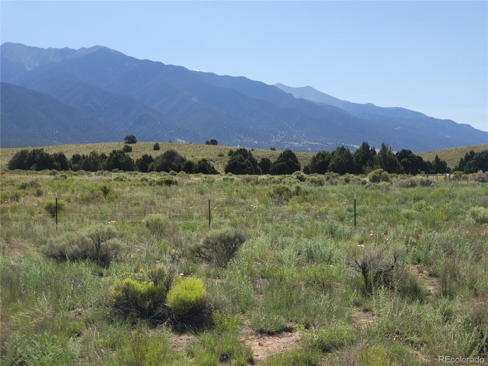 993 Pinon Road Crestone, CO 81131 - Photo 18 of 42 a view of a lush green hillside and a houses
