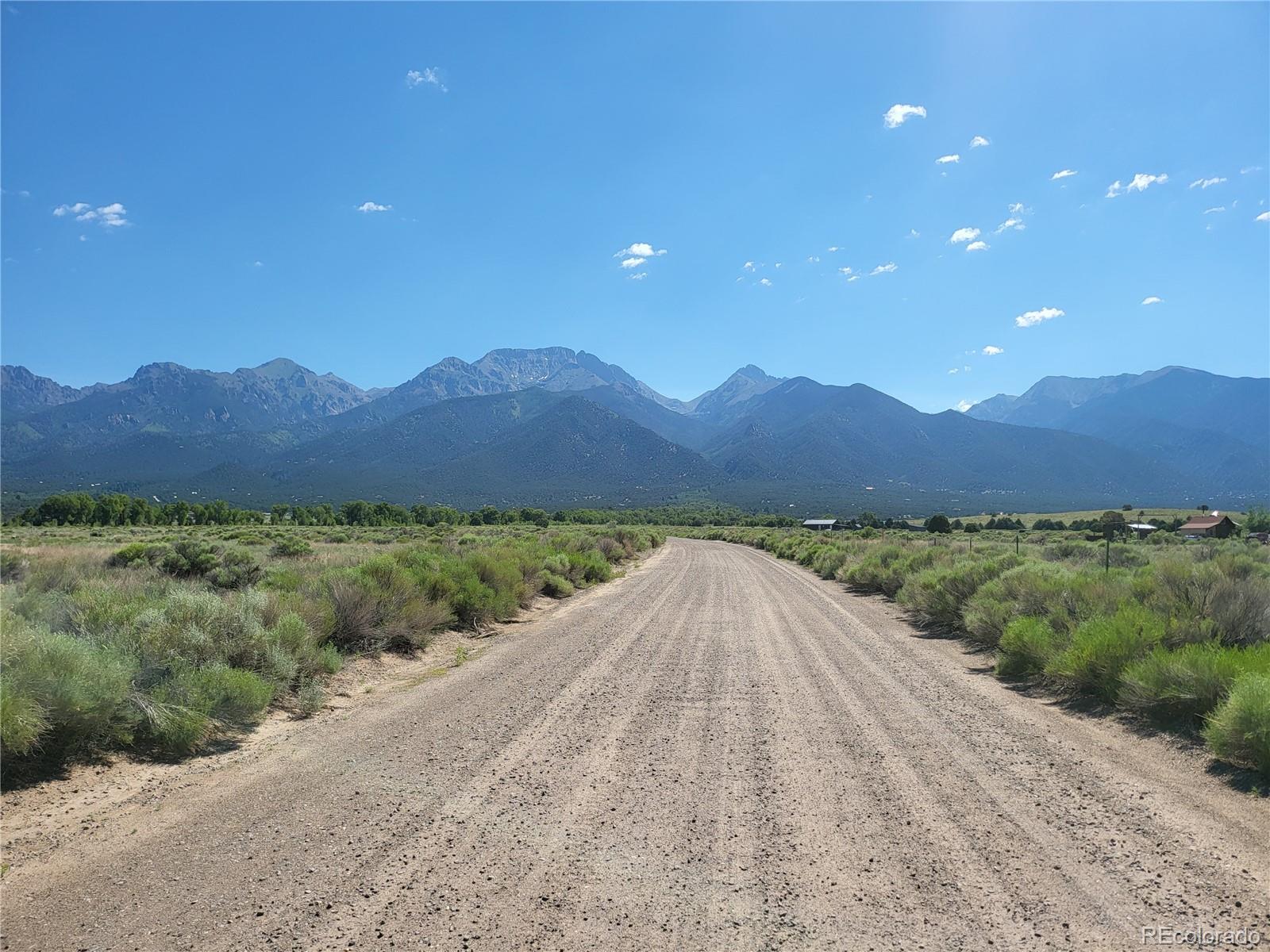 993 Pinon Road Crestone, CO 81131 - Photo 24 of 42 a view of a dry yard with mountains in the background