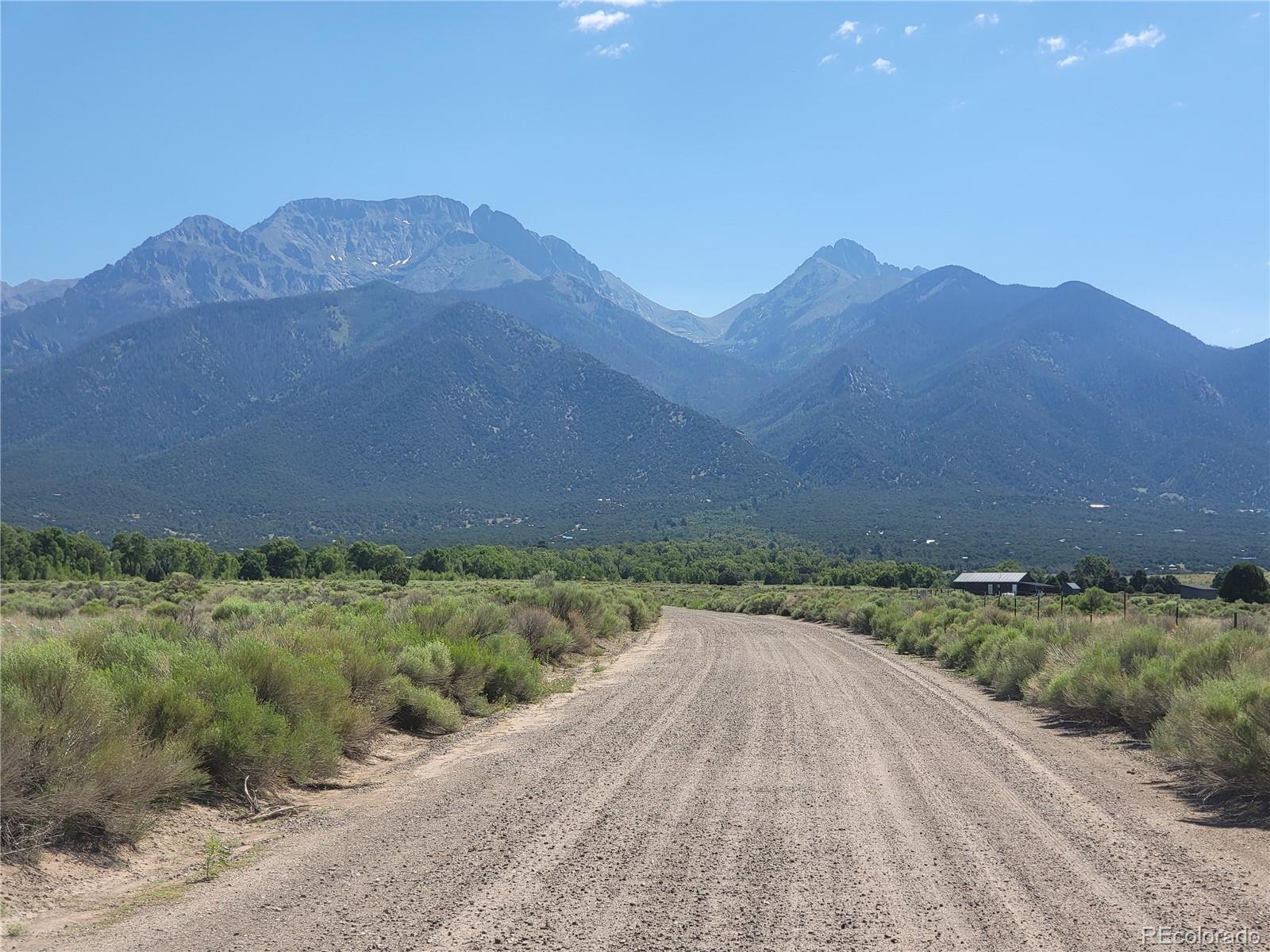 993 Pinon Road Crestone, CO 81131 - Photo 25 of 42 a view of a dry yard with mountains in the background
