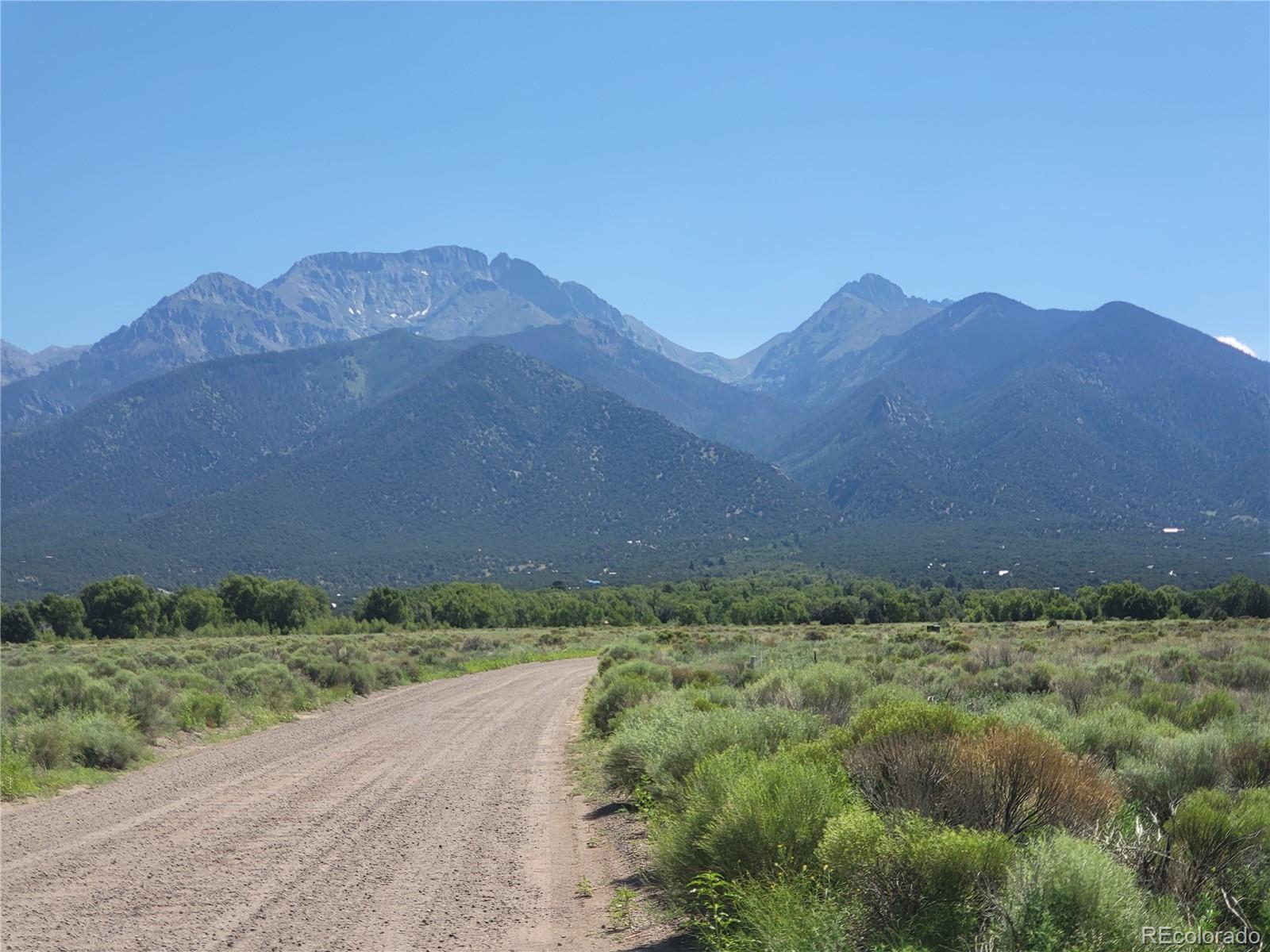 993 Pinon Road Crestone, CO 81131 - Photo 27 of 42 a view of a dry yard with mountains in the background