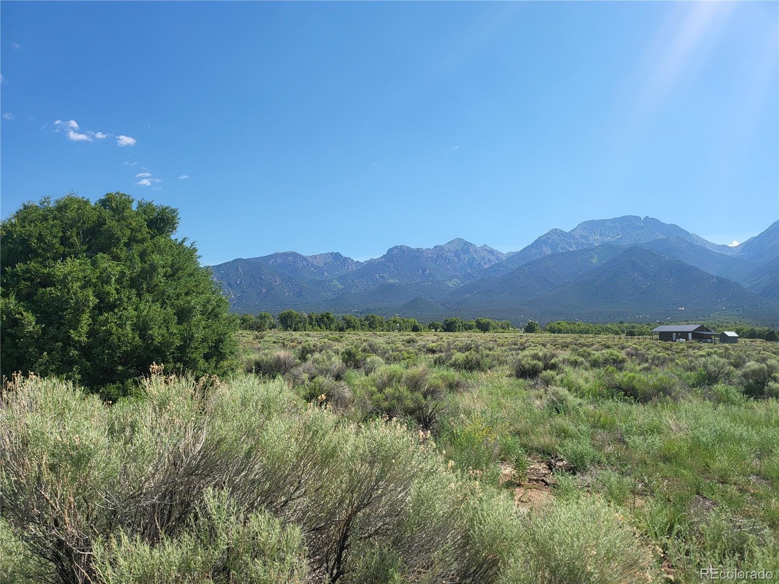 993 Pinon Road Crestone, CO 81131 - Photo 9 of 42 a view of a lush green hillside and a houses