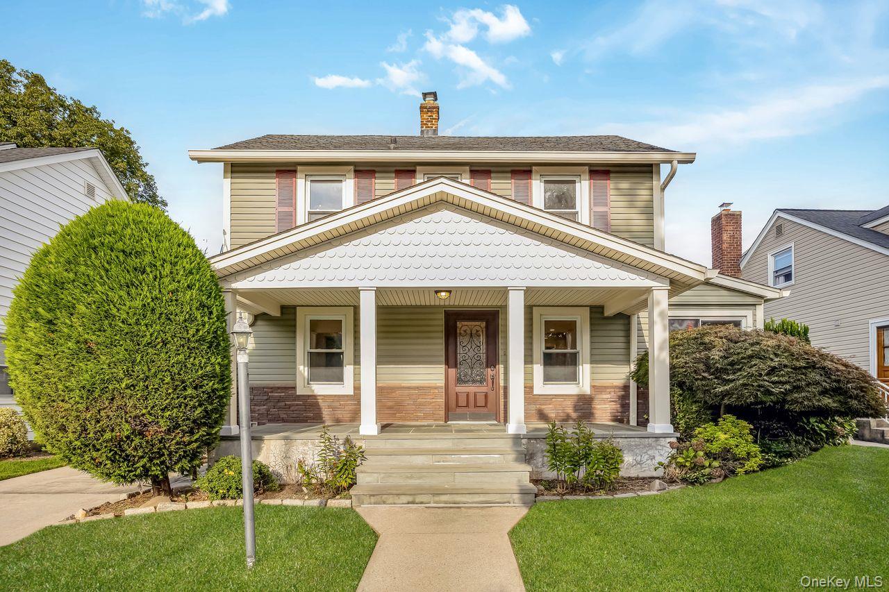 134 Marcellus Road Mineola, NY 11501 - Photo 1 of 1 View of front of property with a front yard, a porch, and a chimney