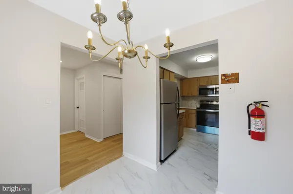 a kitchen with stainless steel appliances granite countertop a refrigerator a stove a sink and a microwave