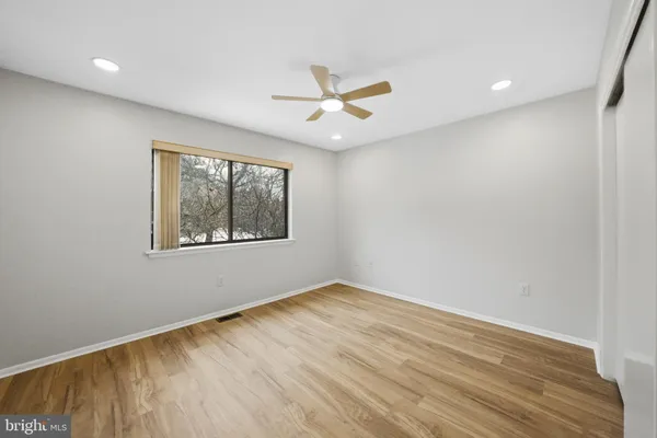 a view of room with window and ceiling fan