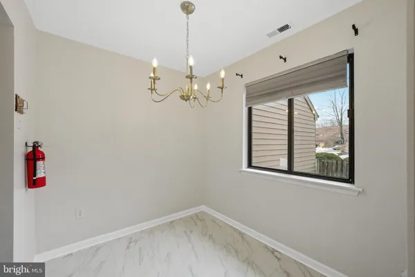 a view of a room with window and chandelier