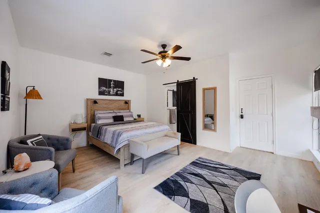 a bedroom with furniture and a chandelier