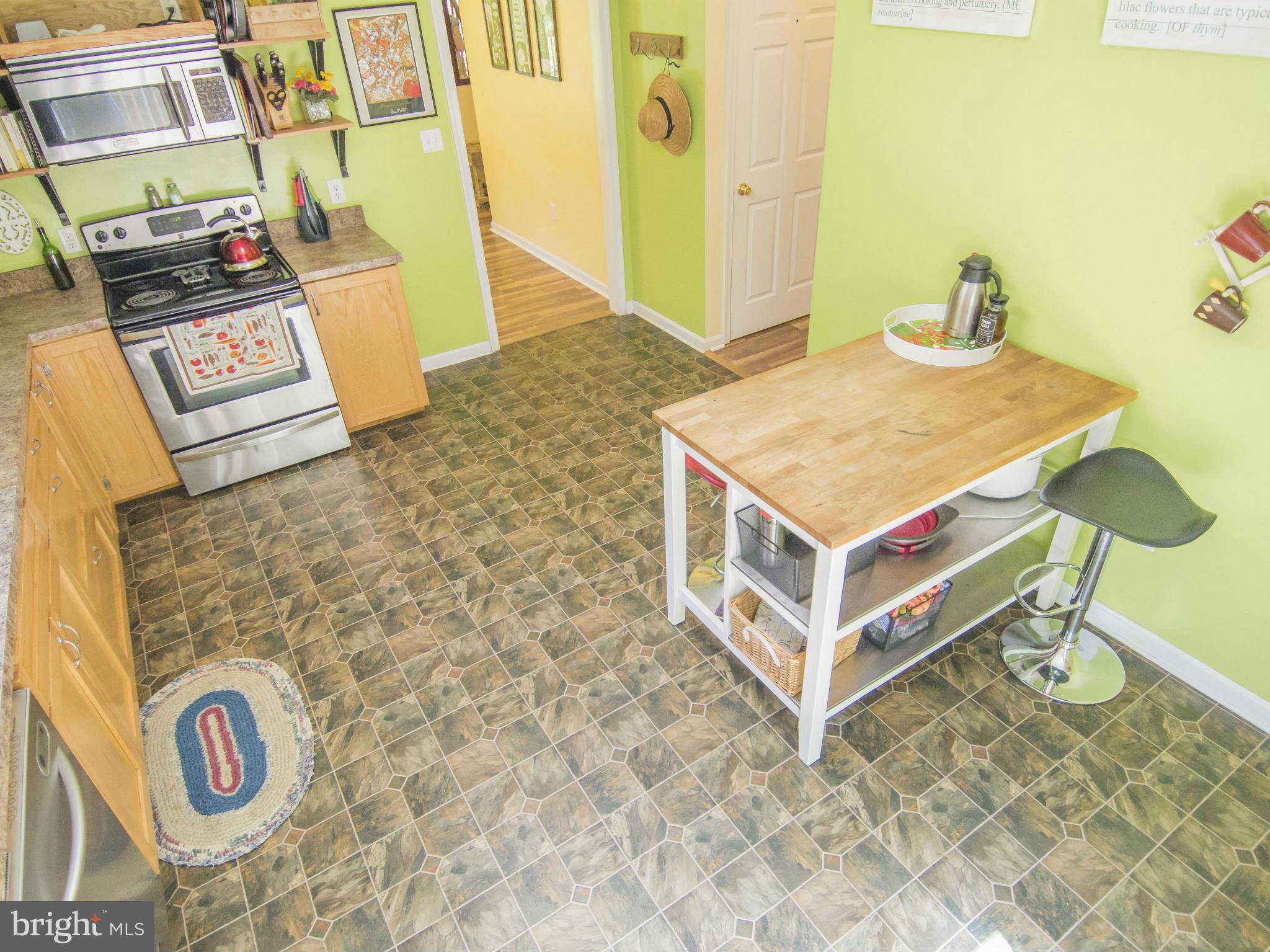 4330 Harvey Road Huntingtown, MD 20639 - Photo 14 of 30 a living room with a table and a stove