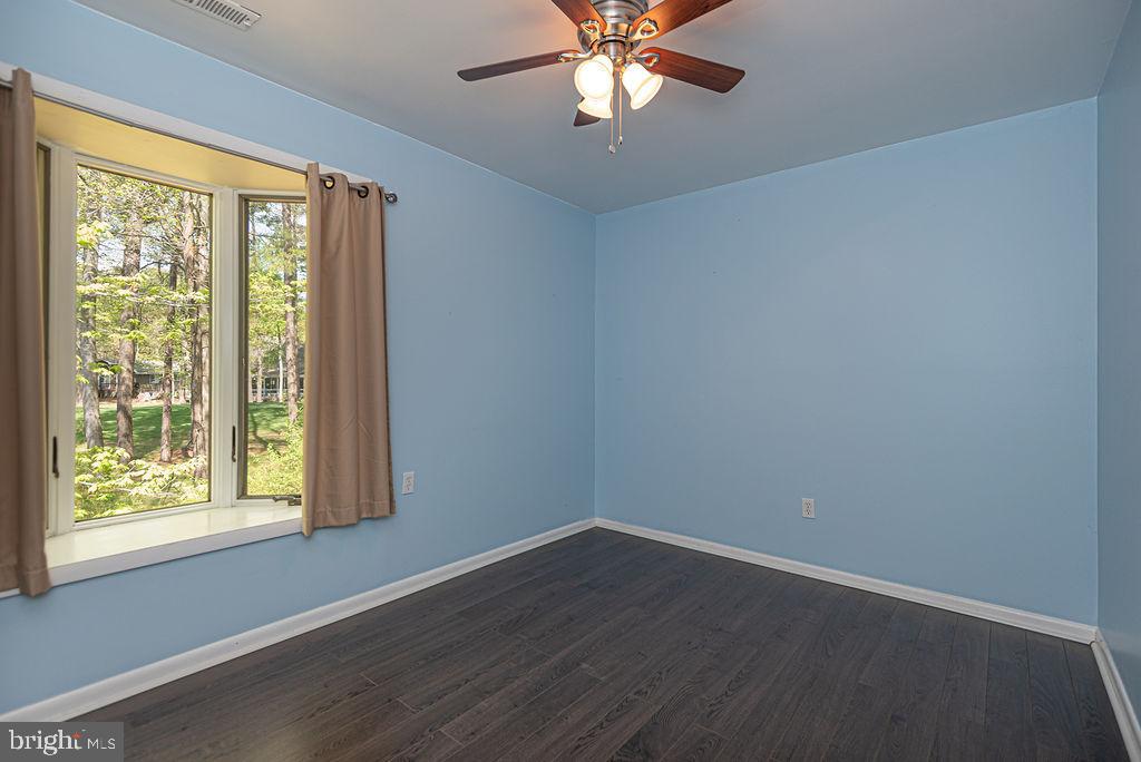 63 Drawbridge Road Ocean Pines, MD 21811 - Photo 45 of 102 a view of an empty room with wooden floor and a window