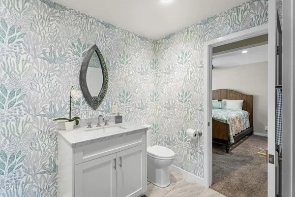 a bedroom with a bed and a mirror