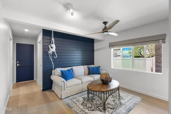 a spacious bedroom with a bed and a flat screen tv