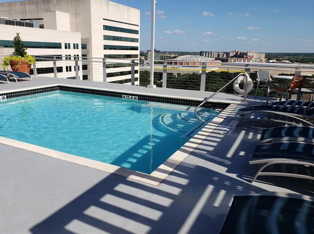 1122 Jackson Street, Unit 303 Dallas, TX 75202 - Photo 18 of 18 a view of a swimming pool with a chair and potted plants