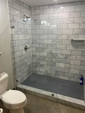 a bathroom with a toilet and shower