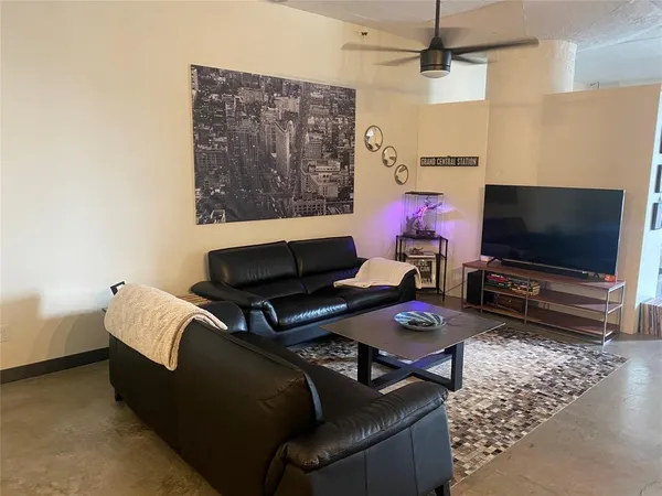 a living room with furniture and a flat screen tv
