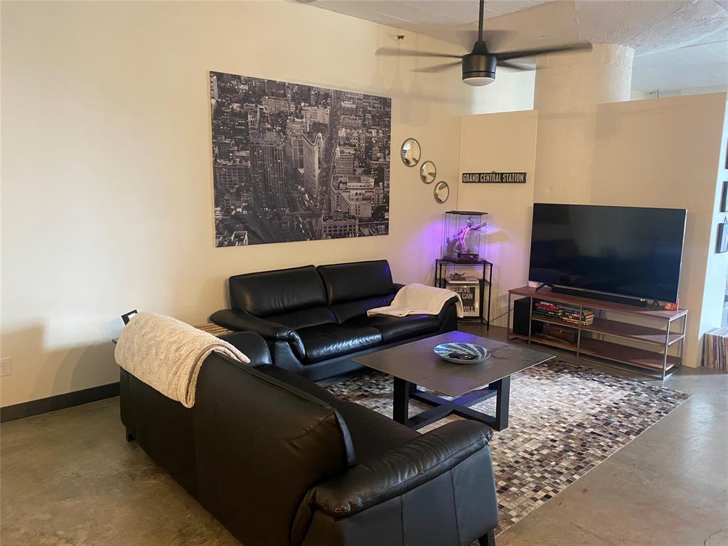 1122 Jackson Street, Unit 303 Dallas, TX 75202 - Photo 5 of 18 a living room with furniture and a flat screen tv