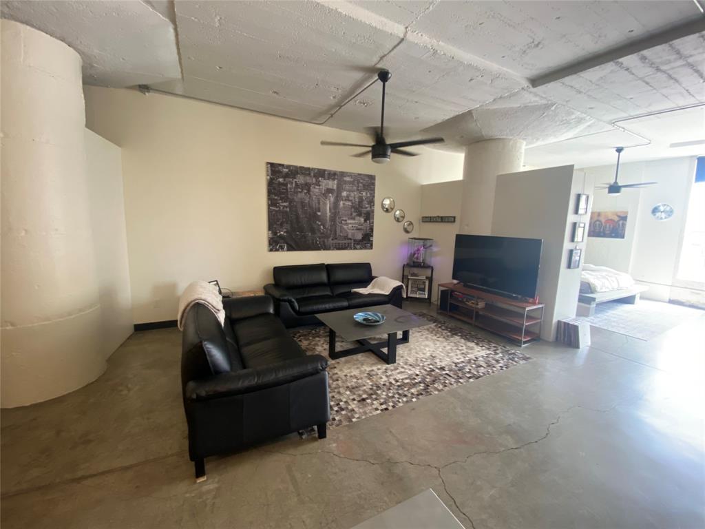 1122 Jackson Street, Unit 303 Dallas, TX 75202 - Photo 7 of 18 a living room with furniture and a flat screen tv
