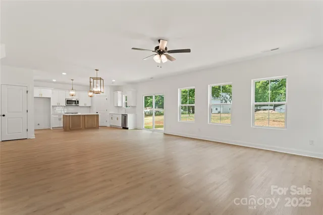 a view of an empty room with a ceiling fan