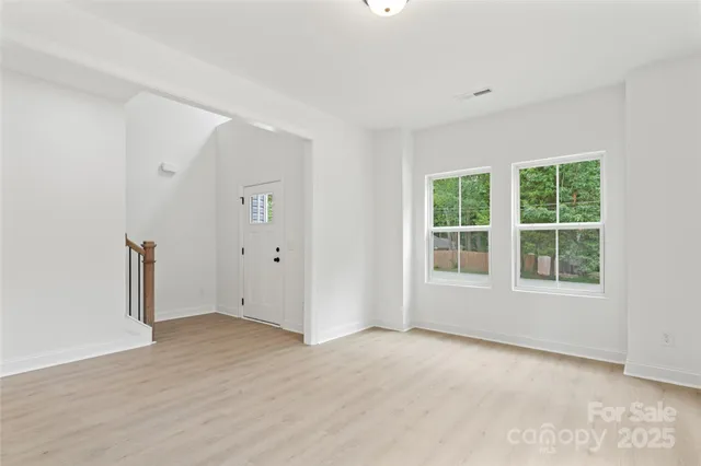 an open kitchen with granite countertop a stove and dishwasher with wooden floor