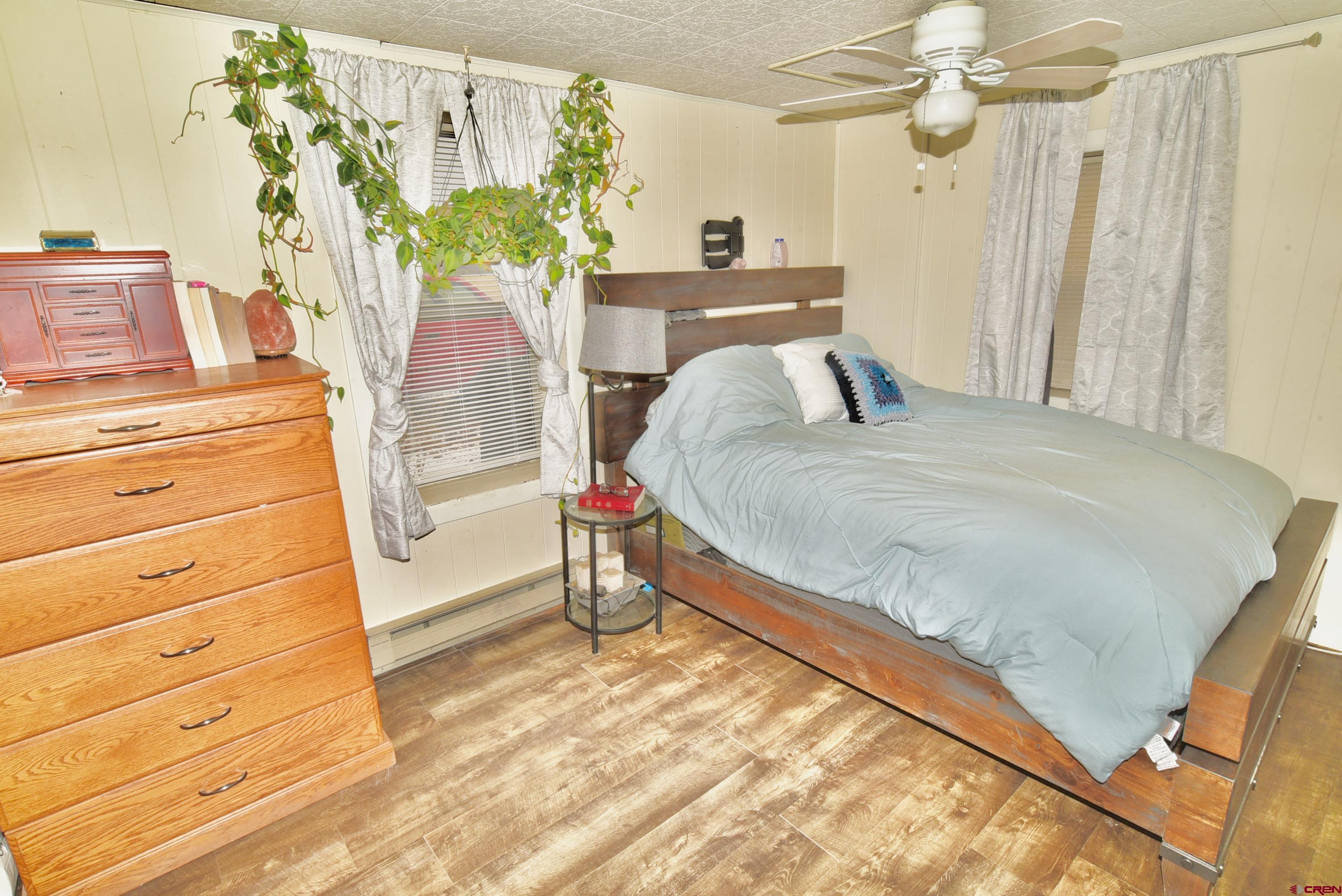 839 B Street Delta, CO 81416 - Photo 14 of 27 a bedroom with a bed and a chandelier