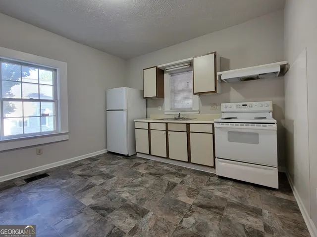 a kitchen with a stove and a sink