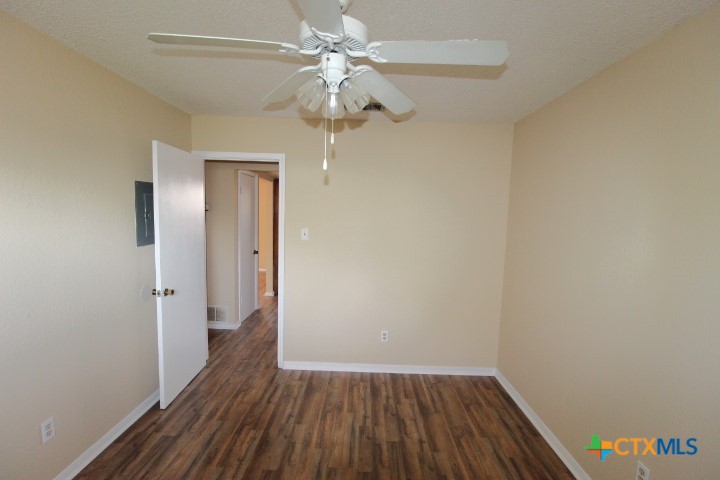 304 Erby Avenue, Unit C Copperas Cove, TX 76522 - Photo 5 of 9 wooden floor in an empty room with a window