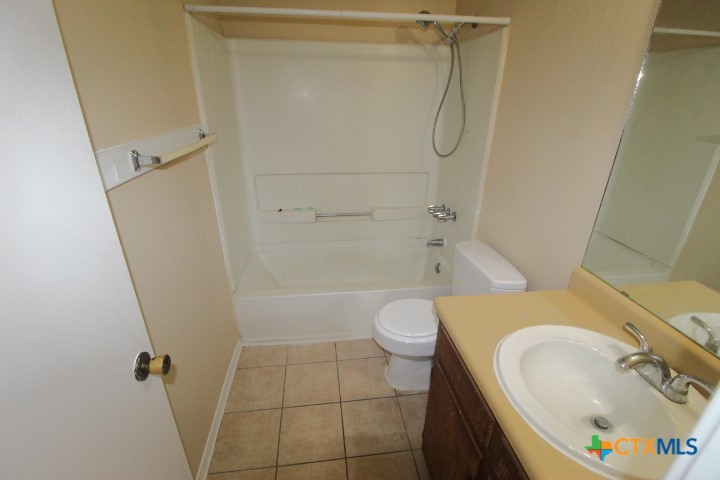 304 Erby Avenue, Unit C Copperas Cove, TX 76522 - Photo 6 of 9 a bathroom with a sink a toilet and shower