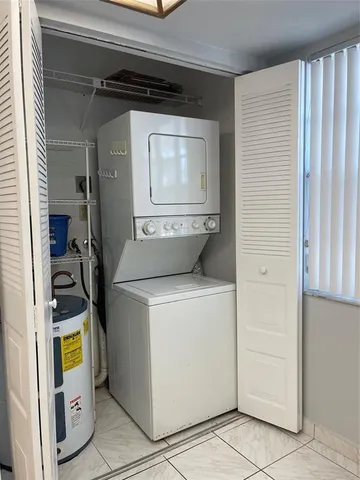 a kitchen with granite countertop a sink stainless steel appliances and cabinets