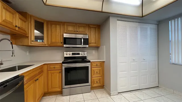 a kitchen with stainless steel appliances granite countertop a stove and a microwave
