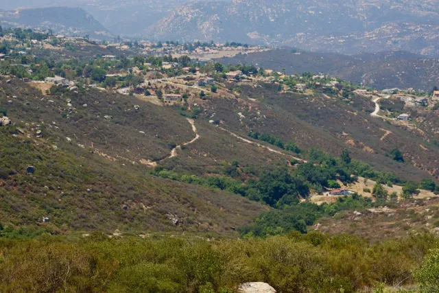 a view of a mountain range with trees in the background