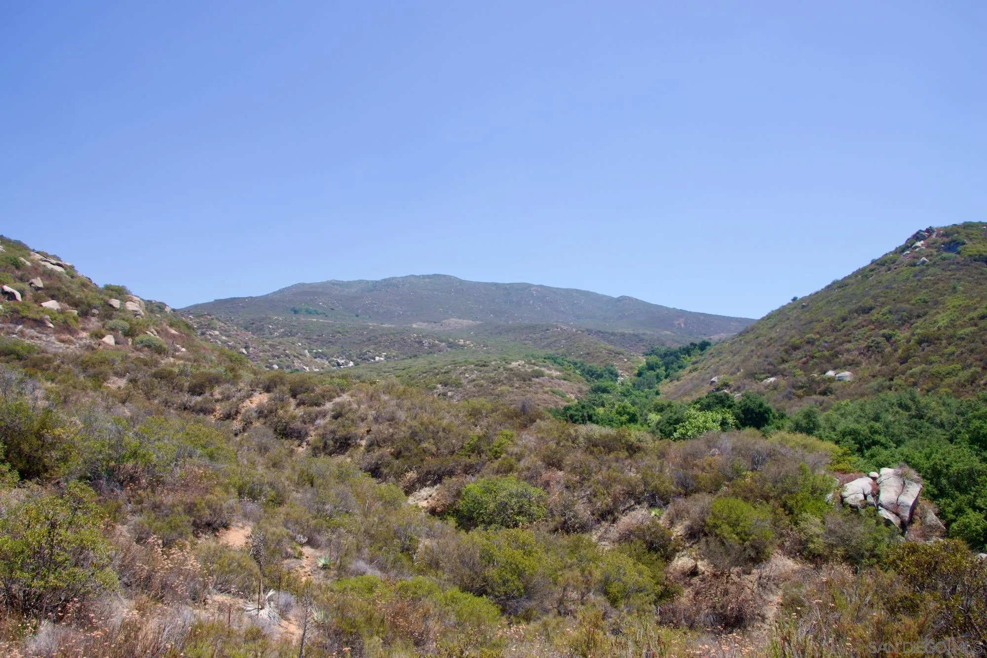 Victoria Drive, Unit 18 Alpine, CA 91901 - Photo 57 of 58 a view of a mountain range with trees in the background
