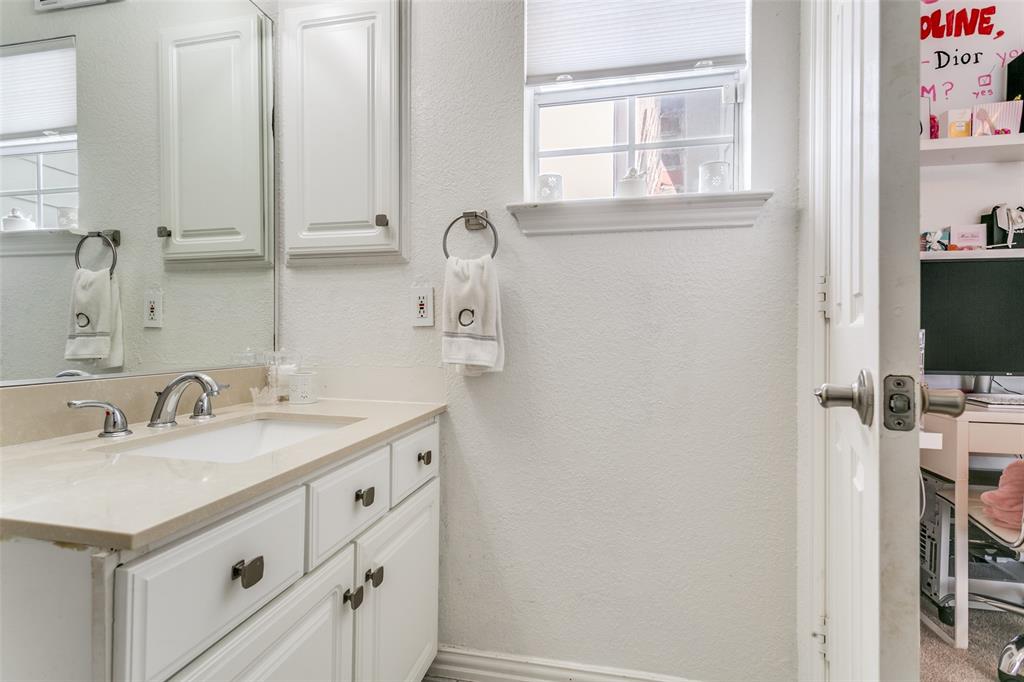 1509 Blue Mesa Road Carrollton, TX 75007 - Photo 31 of 35 a bathroom with a sink and a mirror
