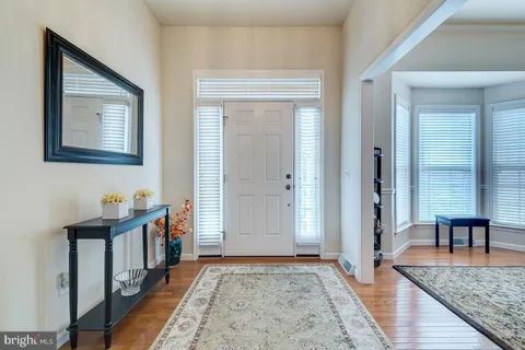a view of hallway with stairs and wooden floor