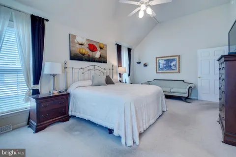 a bedroom with a bed and a lamp on table