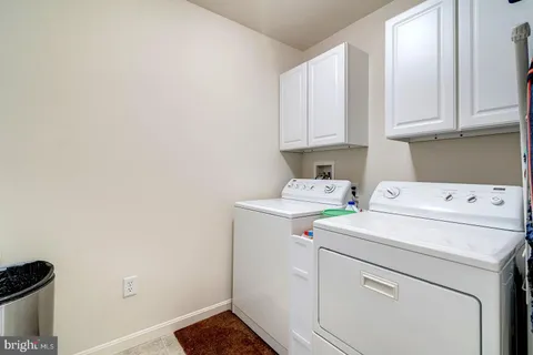 a view of walk in closet with clothes