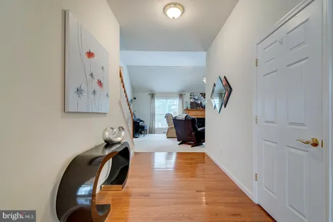 a dining room with furniture a rug and a chandelier