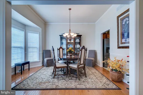 a view of a dining room with furniture and chandelier