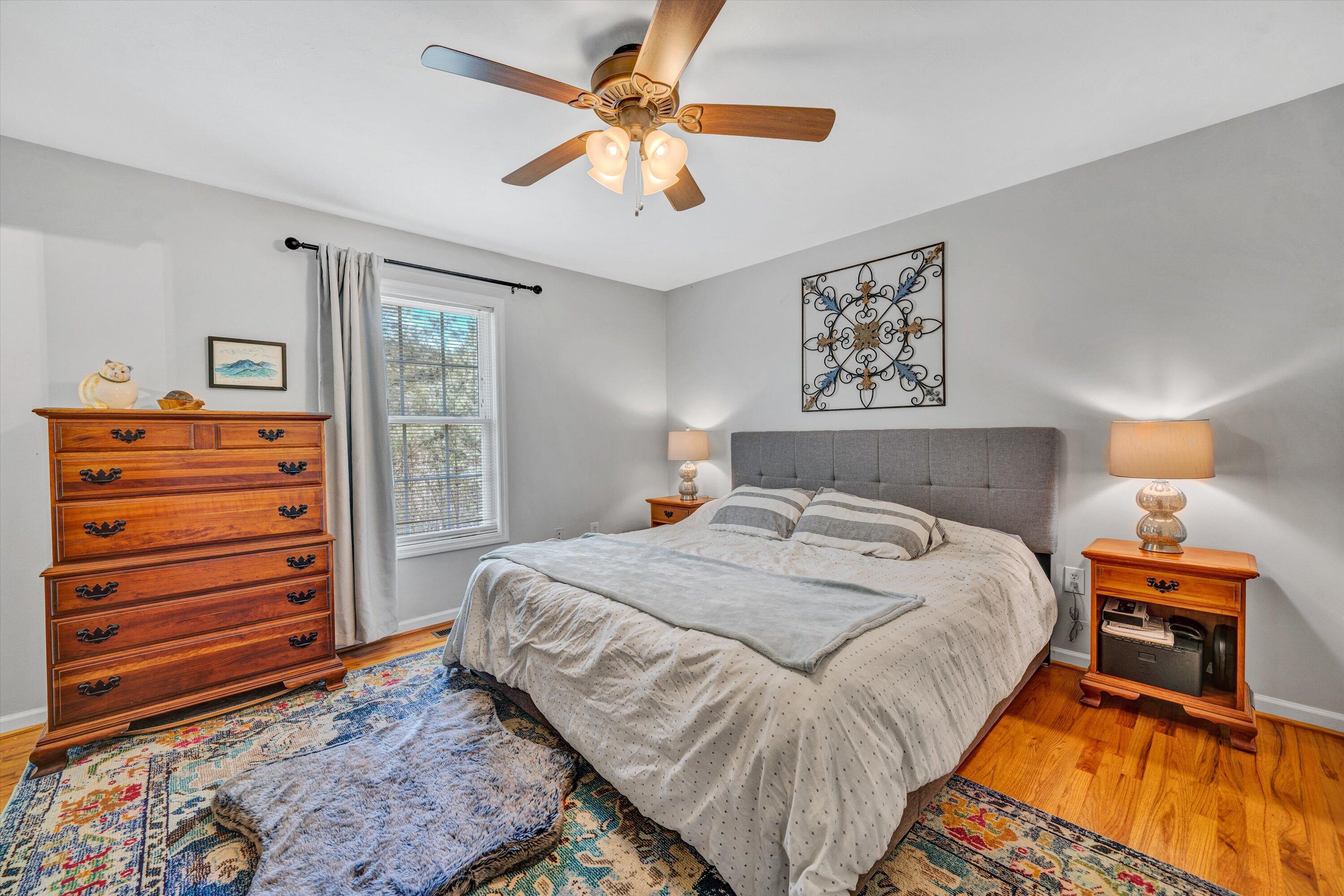 781 Holland Road Callaway, VA 24067 - Photo 19 of 42 a bedroom with a bed and a chandelier