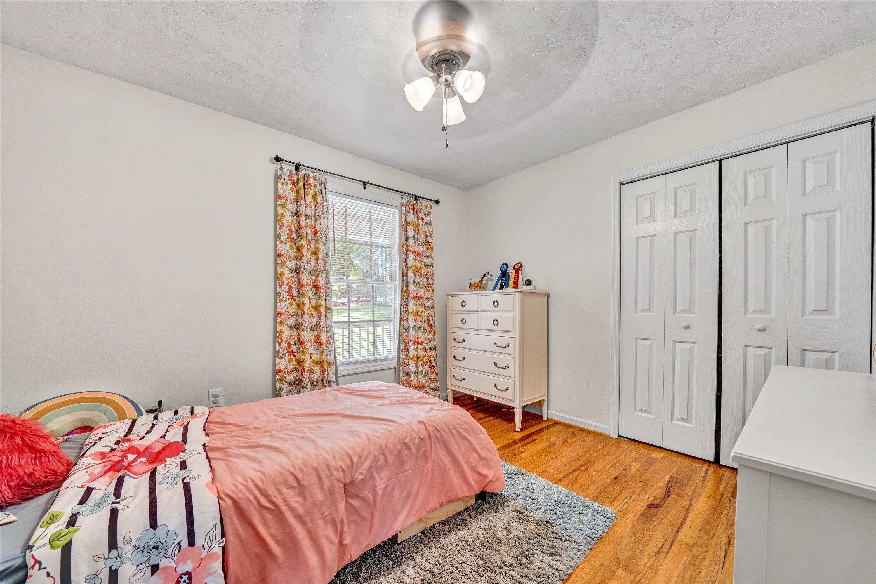 781 Holland Road Callaway, VA 24067 - Photo 23 of 42 a bedroom with a bed and a chandelier