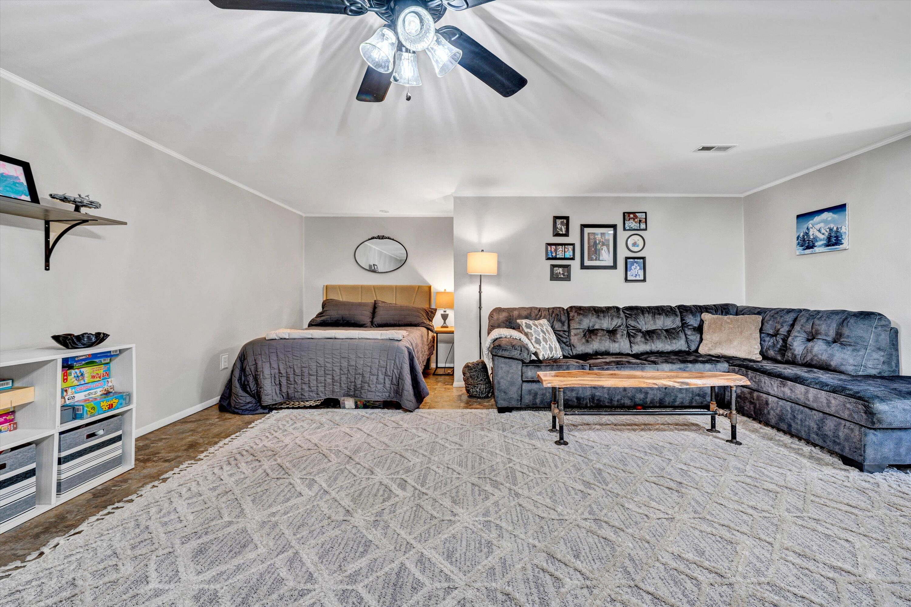 781 Holland Road Callaway, VA 24067 - Photo 29 of 42 a bedroom with a bed a couch and a chandelier