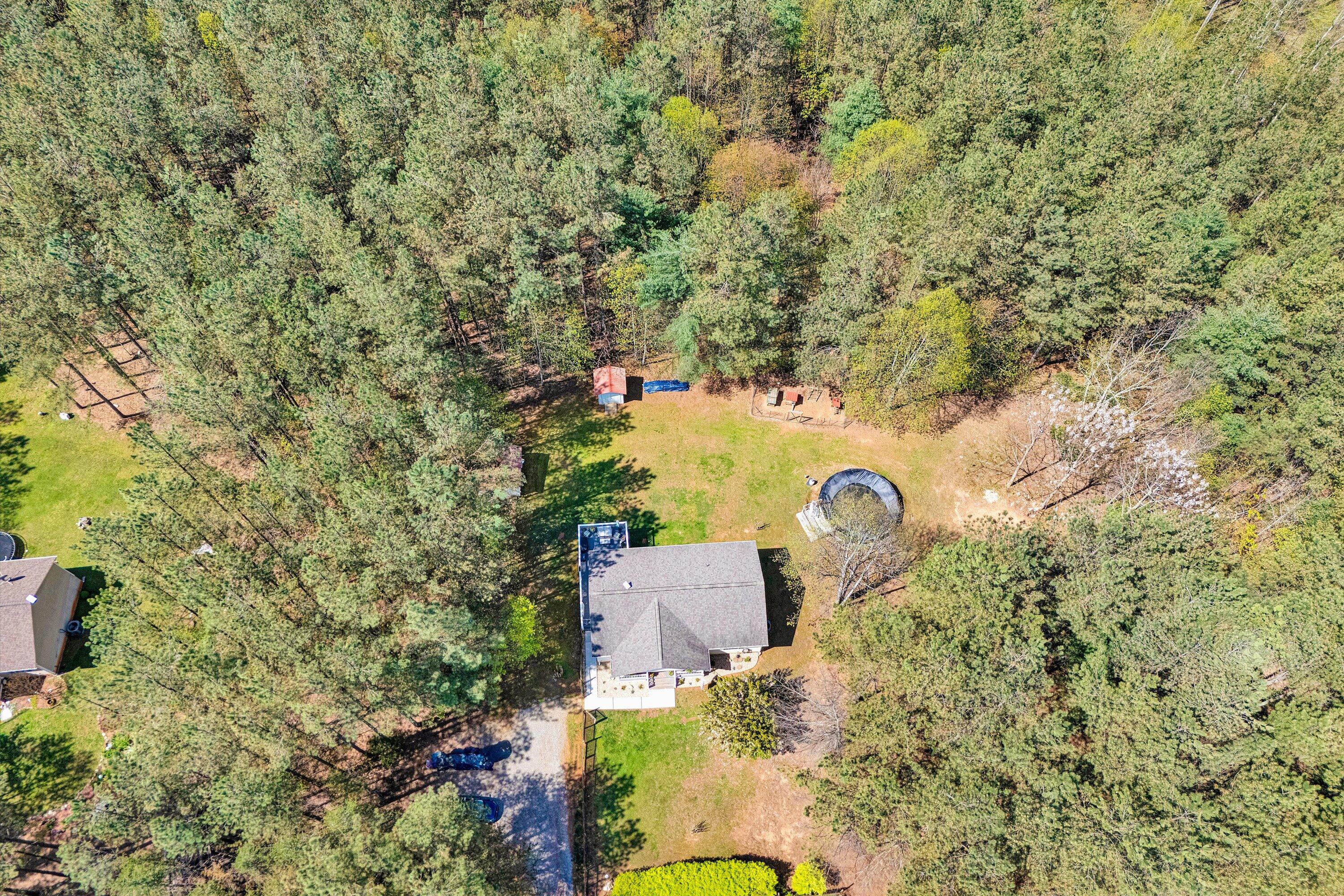 781 Holland Road Callaway, VA 24067 - Photo 3 of 42 an aerial view of a house with a yard and large trees