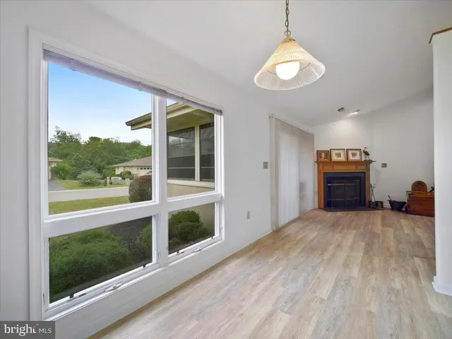 a view of a livingroom with furniture wooden floor and window