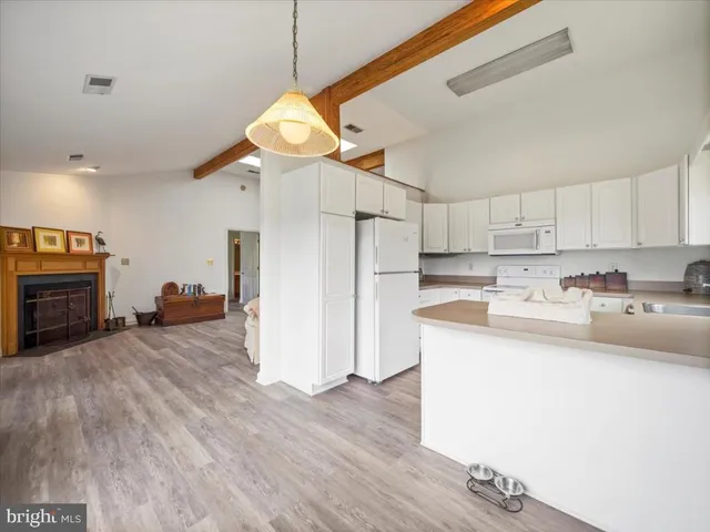 a view of a kitchen with a sink and a refrigerator