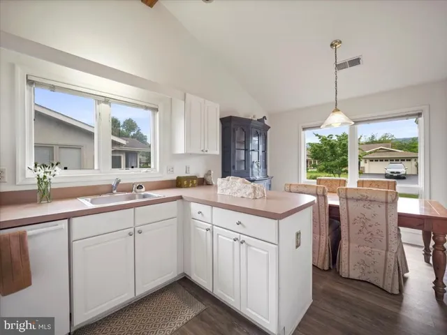 a kitchen with sink cabinets and wooden floor