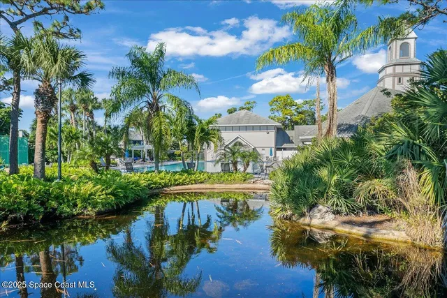 a view of a lake with a yard and potted plants