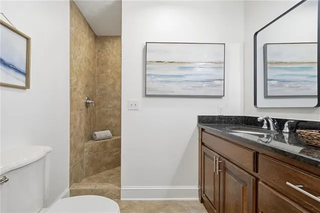 a bathroom with a sink and mirror with toilet
