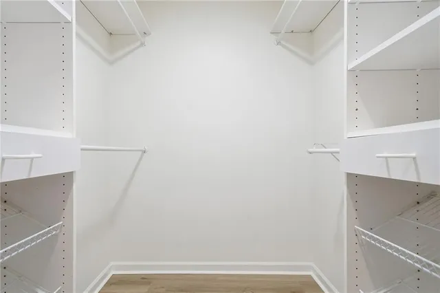 a view of walk in closet with empty racks