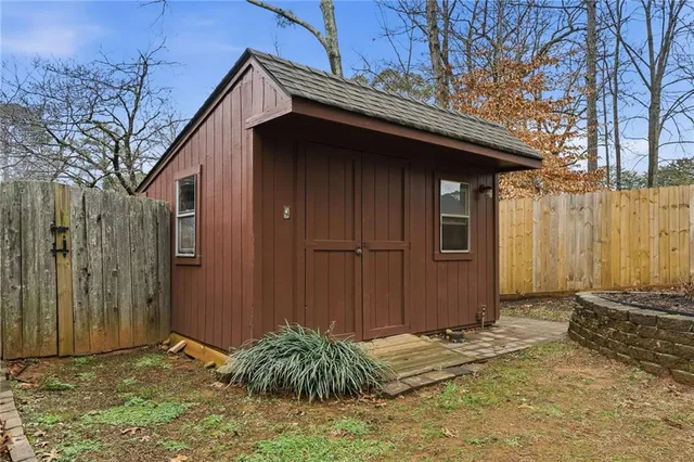 a view of a patio with table and chairs and wooden fence