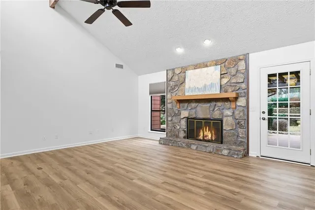 a view of a livingroom with a fireplace and a window