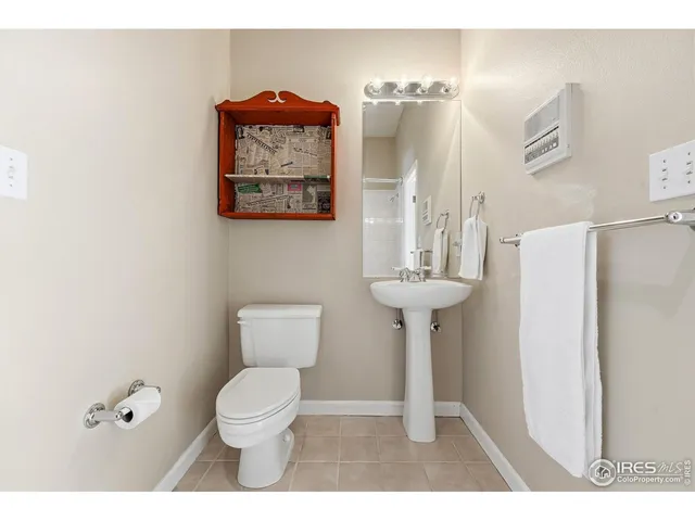 a bathroom with a toilet a sink and a mirror